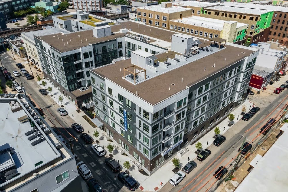 Aerial view of The Mill at York Station apartment building in Philadelphia, Pennsylvania, showing the full property exterior and surrounding neighborhood streets.